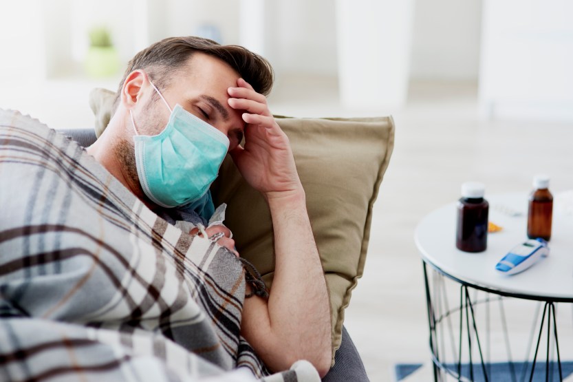 Ill man sleeping with a face mask